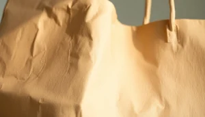 High-quality paper bag being filled with eco-friendly materials for packaging a product,